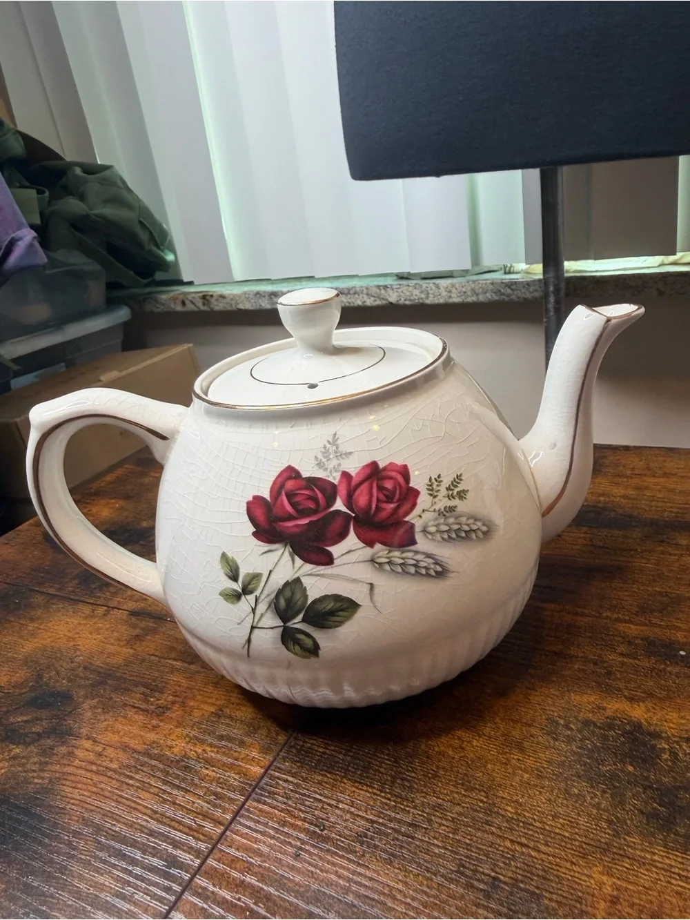 Vintage Ellgreave England red rose teapot featuring delicate gold trim.
